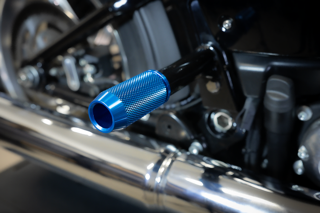 CNC crashbar sliders for Harley-Davidson, blue, installed on a Softail rear crashbar